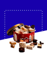Boîte en métal rouge contenant nougats, calisson et chocolats, disponible en deux formats.