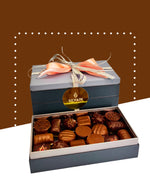 Assorted dark and milk chocolates in a decorative box by SCHAAL.