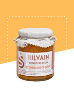 Jar of clementine confiture with a vibrant orange color and a simple label design.